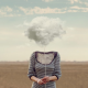Woman holding cloud on string in place of head