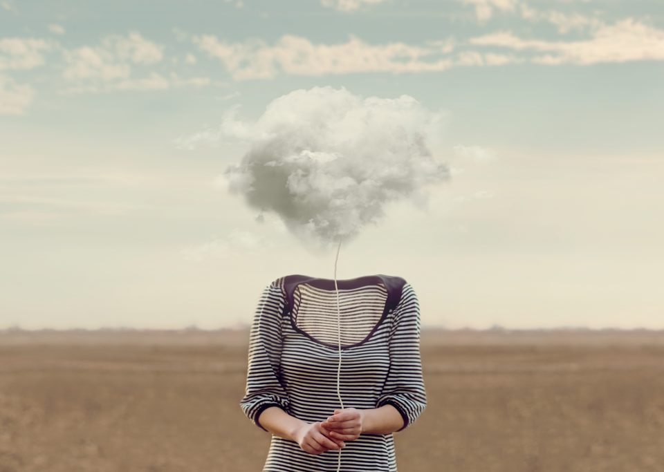 Woman holding cloud on string in place of head