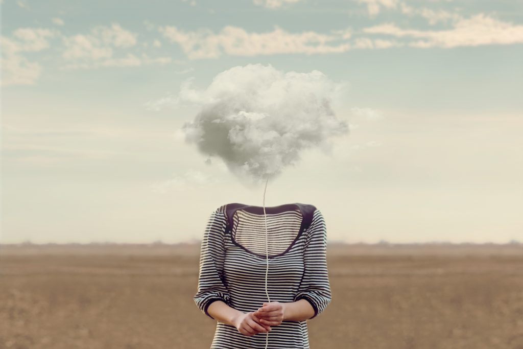 Woman holding cloud on string in place of head