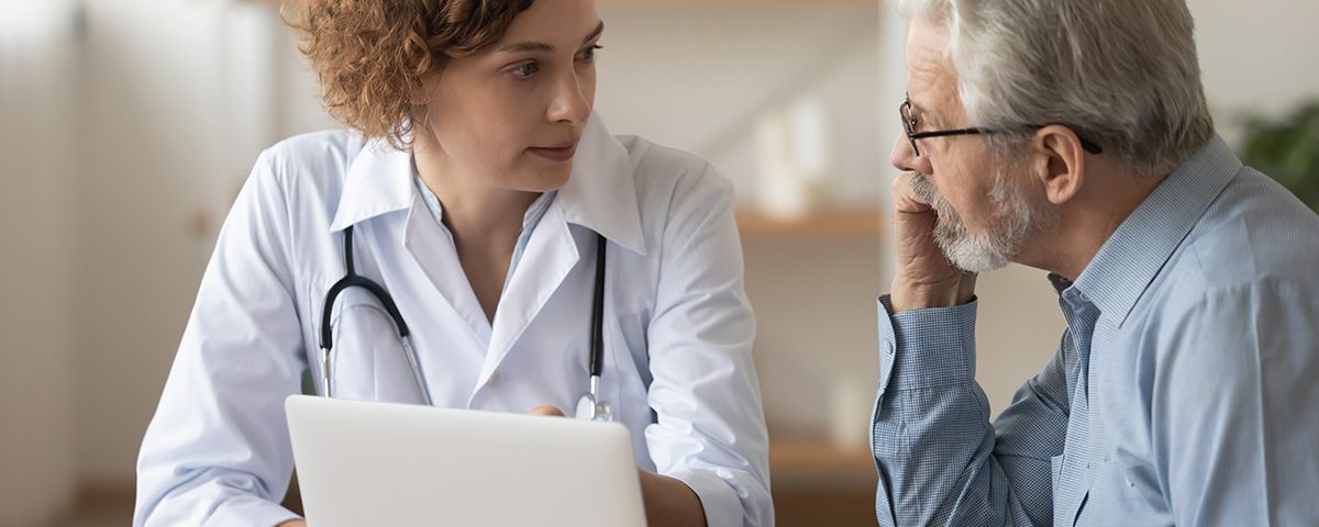 Doctor and patient talking over laptop