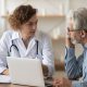 Doctor and patient talking over laptop