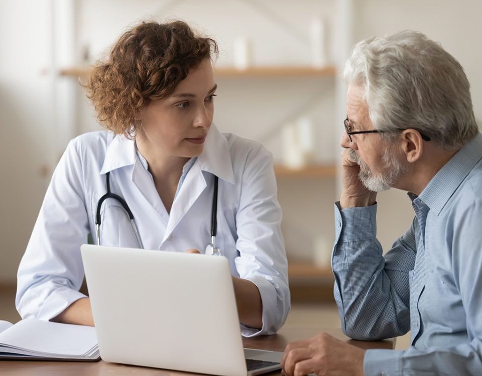 Doctor and patient talking over laptop