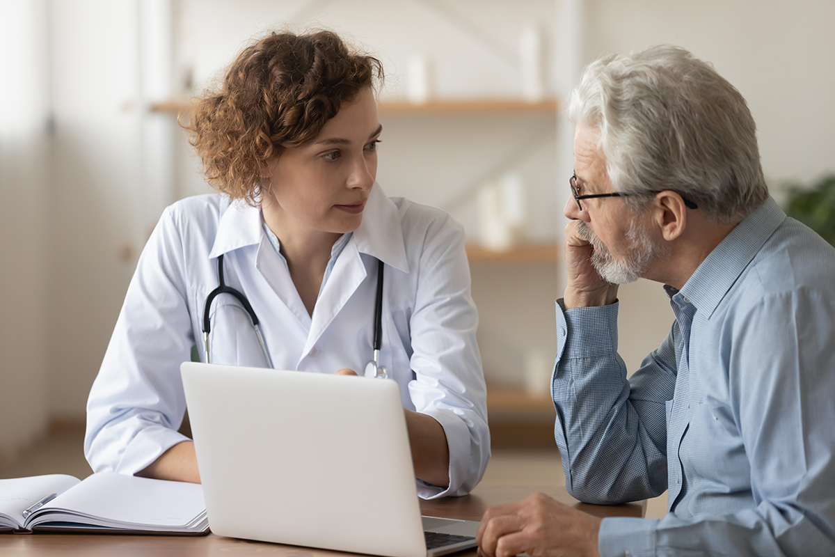 Doctor and patient talking over laptop