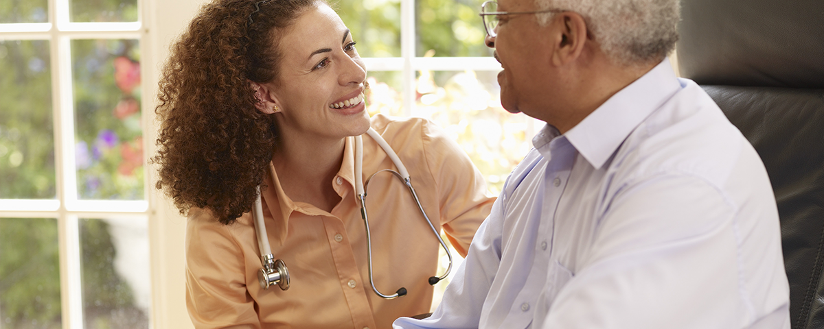 Doctor talking with older male patient