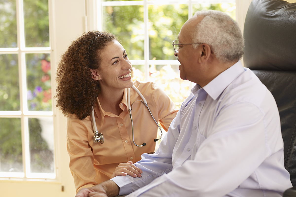 Doctor talking with older male patient