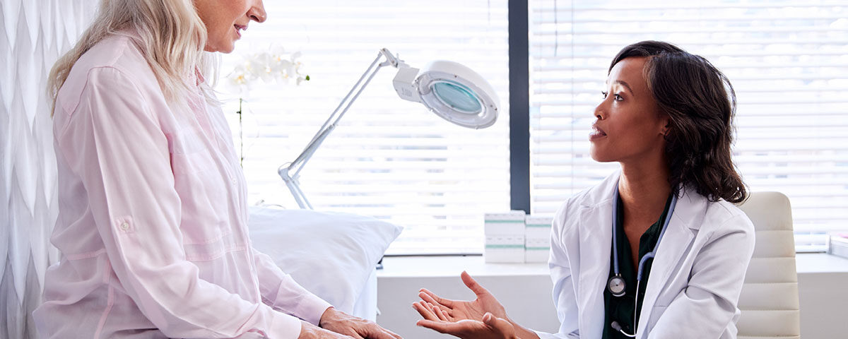 Patient on exam table talking to doctor